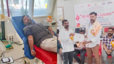 Donor donating blood at a medical camp with officials presenting a certificate of appreciation.