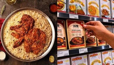 Close-up of a plate of biryani with fried chicken and a hand holding a spice mix packet.