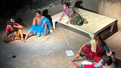 Women performing a traditional dance on stage during a cultural event in Hyderabad.