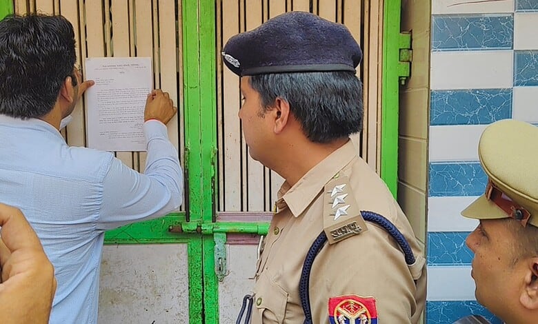 A man in civilian clothes showing documents to police officers at a security checkpoint.