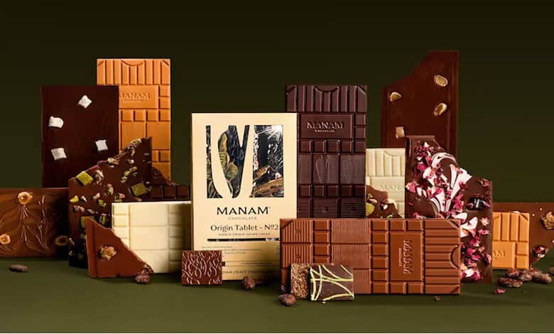 Delicious assorted chocolates with various flavours and textures displayed on a dark background.