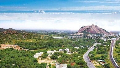 Scenic view of Hyderabad's Medipally area with hills and greenery.