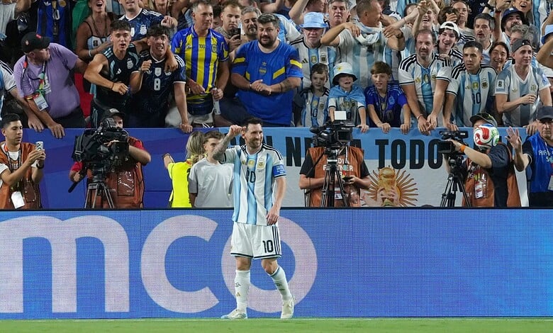 Lionel Messi celebrates his hat trick as Argentina wins 3-0 against Algeria in a football match.