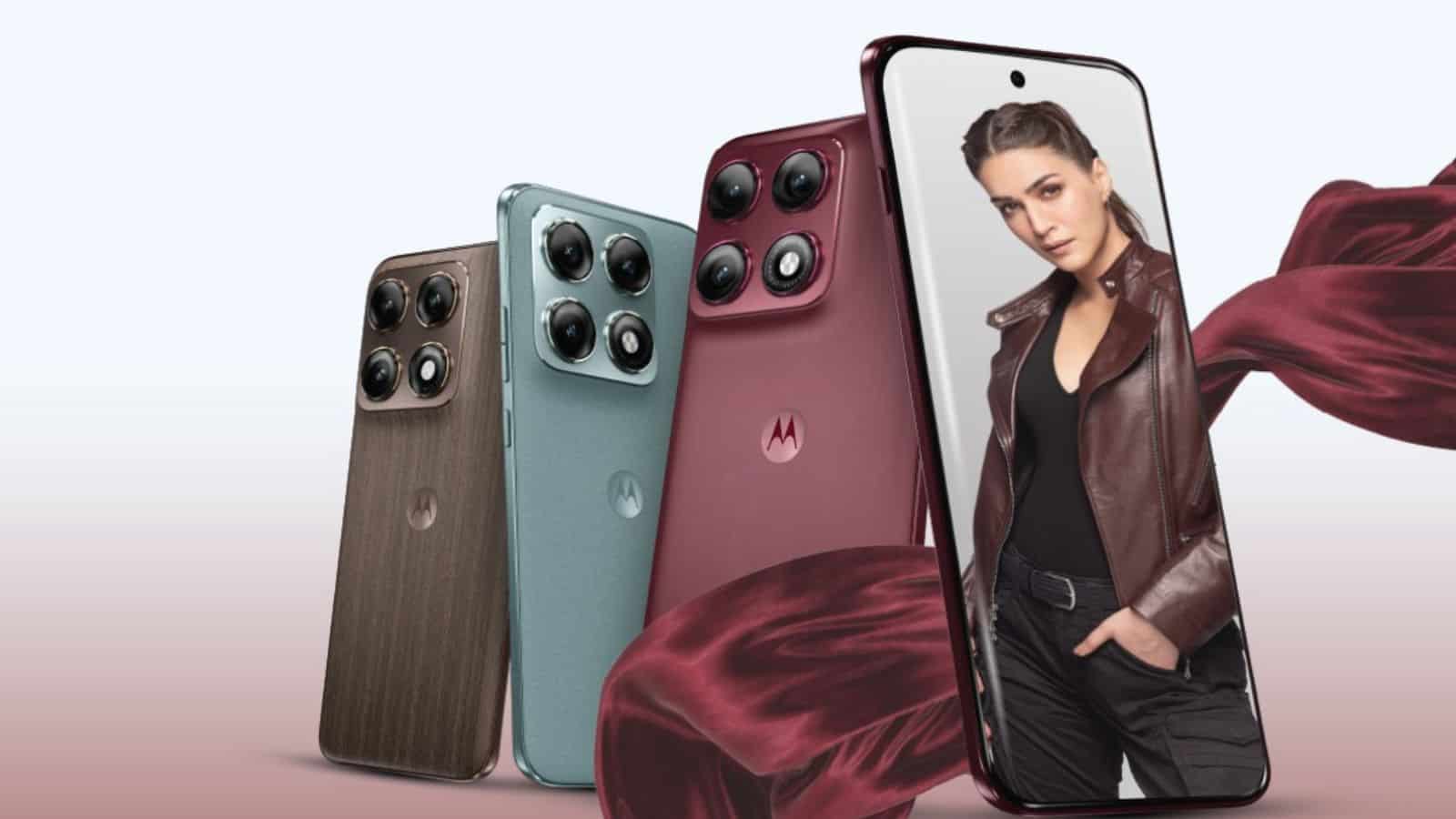 A woman holding a smartphone with multiple camera lenses, showcasing new mobile phone models.
