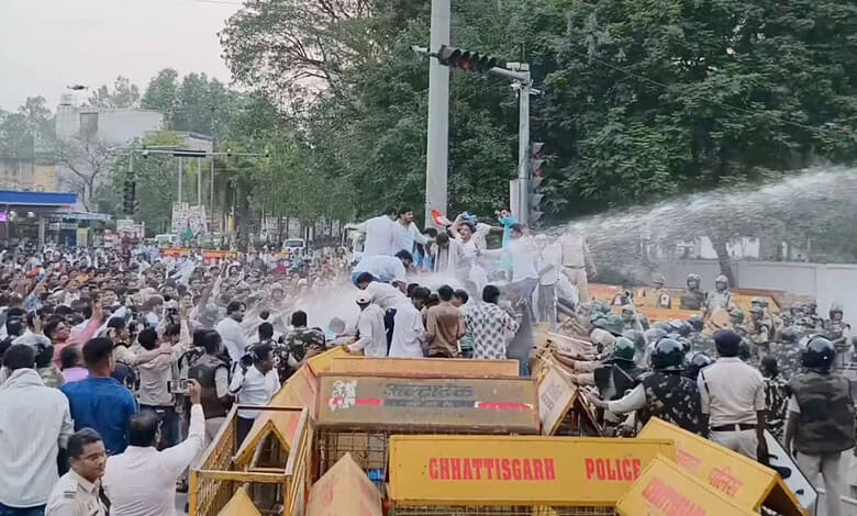Protest in Hyderabad where police use water cannons to disperse a large crowd of protesters on the street.