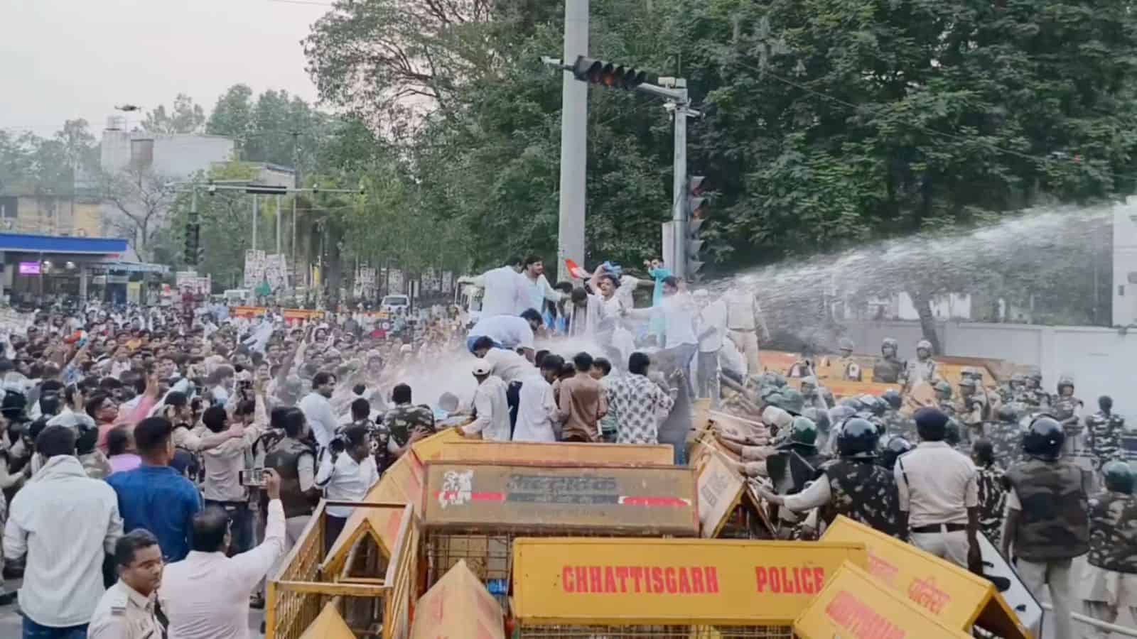 Protest in Hyderabad where police use water cannons to disperse a large crowd of protesters on the street.