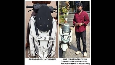 Electric scooter parked outdoors with a person standing beside it, wearing casual attire and a helmet.