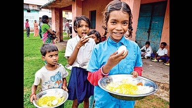 Students having eggs in mid day meal