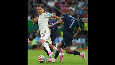 Spain and Uruguay players jostle for the ball