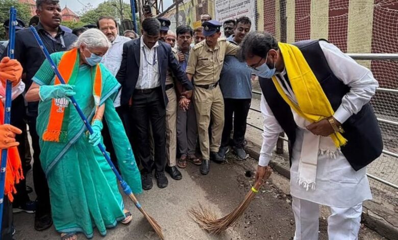Officials and citizens participate in a street cleaning event for the Clean India initiative.