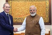 Prime Minister Narendra Modi and Amazon CEO Jeff Bezos shake hands during a meeting.