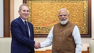 Prime Minister Narendra Modi and Amazon CEO Jeff Bezos shake hands during a meeting.