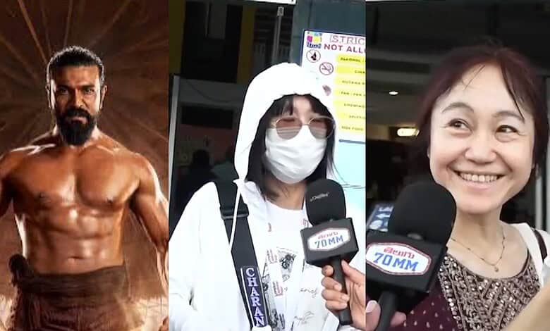 A muscular man being interviewed at Siasat Daily event, with a woman in a mask and another smiling woman.