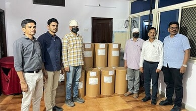Emergency relief team with large boxes of supplies in a room.