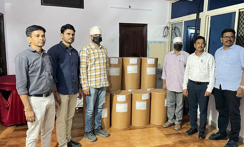 Emergency relief team with large boxes of supplies in a room.