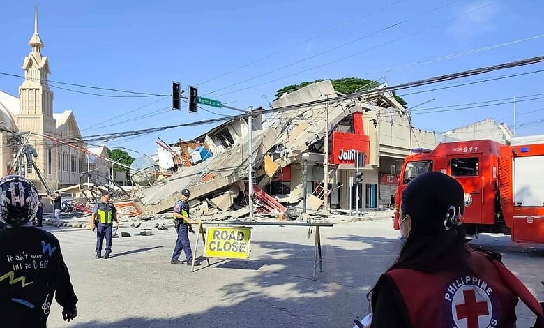 Collapsed building and emergency responders at the scene of a disaster in an urban area.