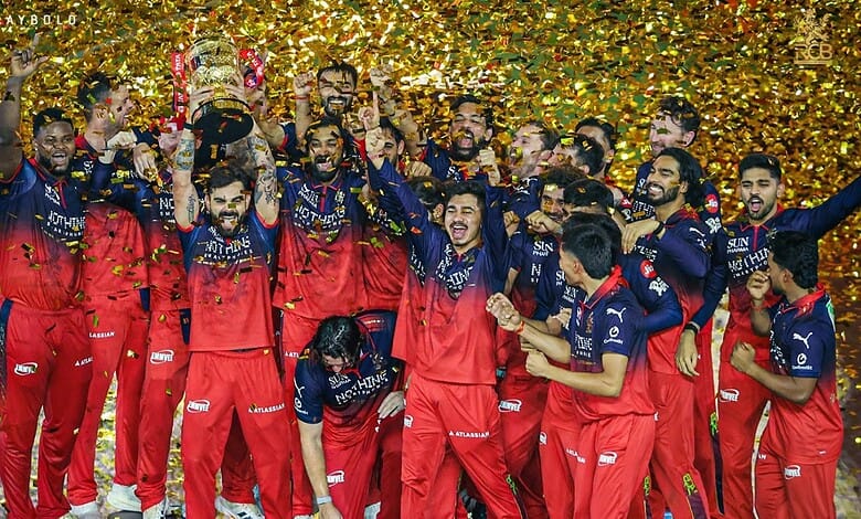 Celebrating cricket team victory with players in red and blue uniforms amidst golden confetti.