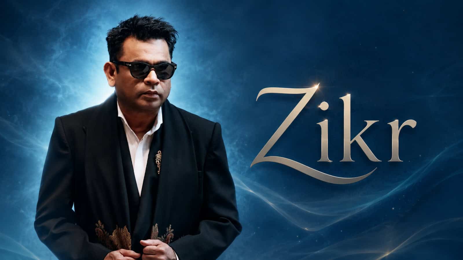 Man in sunglasses and black suit with Zikr text, symbolising spiritual reflection and meditation.