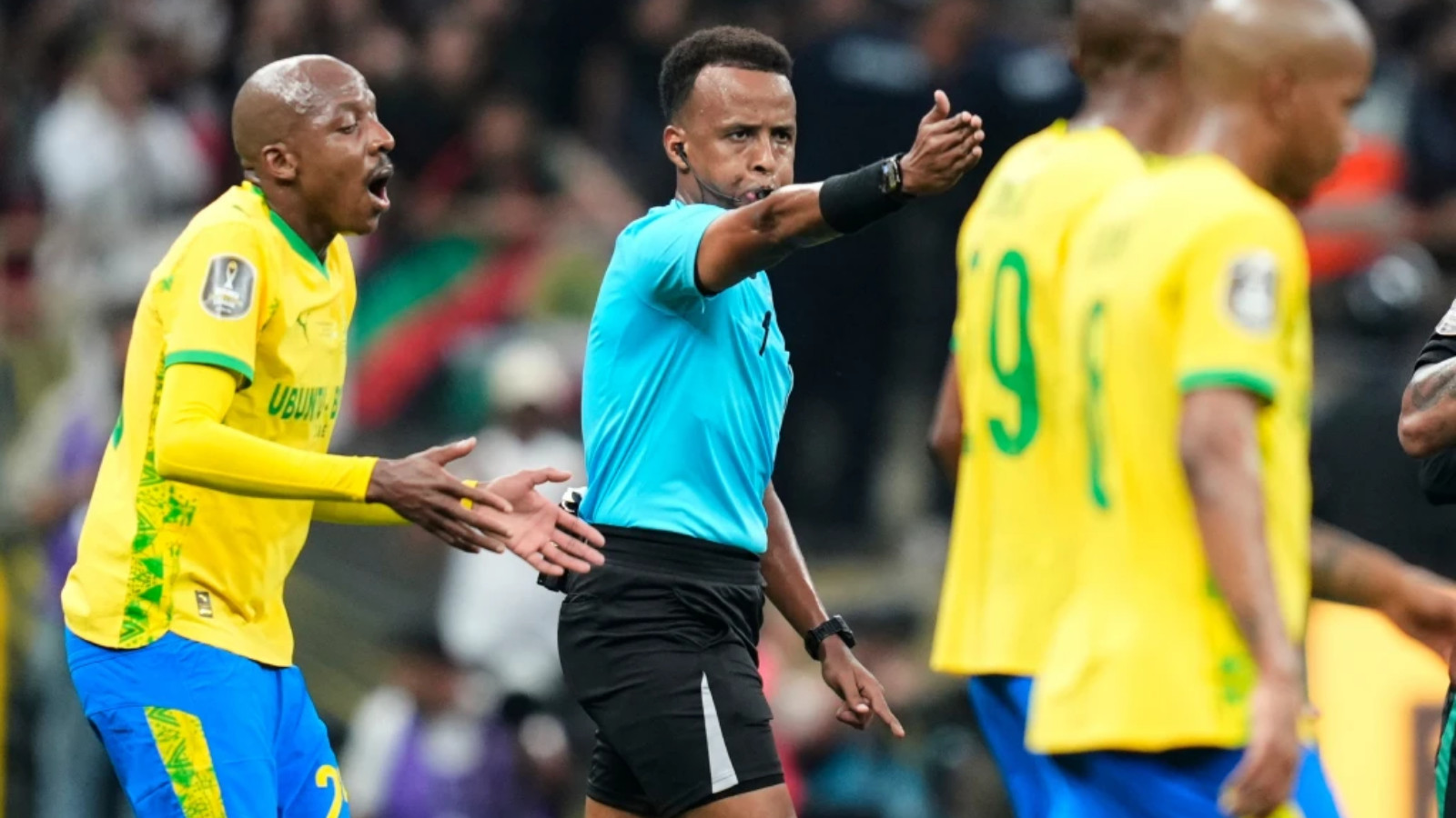 Referee Omar Artan, center, signals a penalty during the CAF Champions League final soccer match between AS FAR Rabat and Mamelodi Sundowns, in Rabat, Morocco