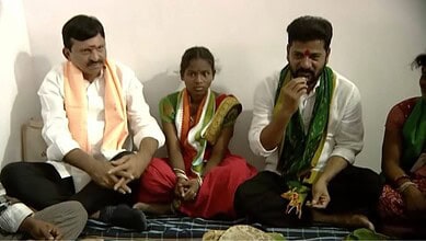 Cultural Indian gathering with men and women in traditional attire, seated on the floor during a communit.