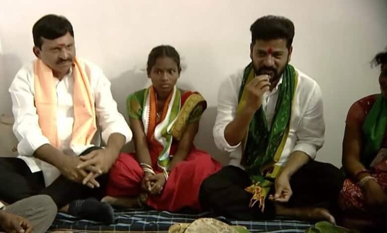 Cultural Indian gathering with men and women in traditional attire, seated on the floor during a communit.