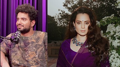 Kangana Ranaut in a purple saree with floral background, looking poised for a photoshoot.