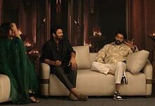 Prabhas and Rana Daggubati sitting on a sofa during a casual event or interview.