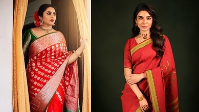 A woman in a red and green traditional saree looking out of a window with curtains.