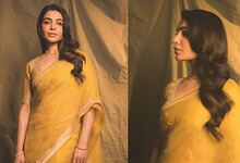 Samantha in a yellow saree at a movie event, looking elegant and stylish.