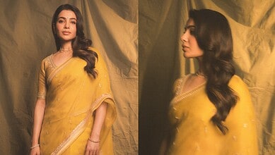 Samantha in a yellow saree at a movie event, looking elegant and stylish.