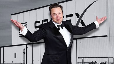 A man in a tuxedo with arms outstretched standing in front of a sign that reads "CREX".