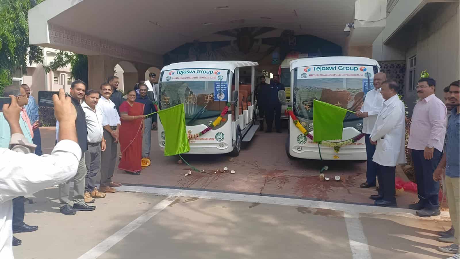 New electric shuttle buses inauguration at Siasat Daily office with officials and guests.