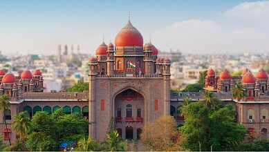 Majestic Hyderabad palace with red domes and lush greenery in the foreground.