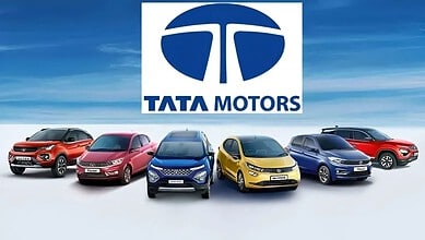 Tata Motors logo with five different Tata car models in front, showcasing the brand's diverse vehicle lin.