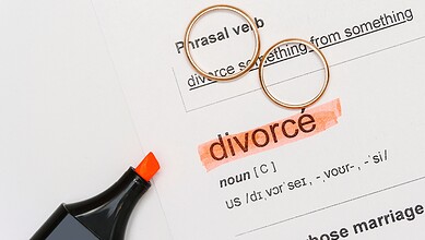 Divorce legal document with rings and highlighted "divorce" term, symbolising separation and legal procee.