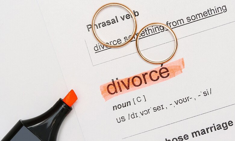 Divorce legal document with rings and highlighted "divorce" term, symbolising separation and legal procee.
