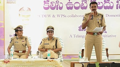 Police officers participating in a public event, with a male officer speaking into a microphone at a form.