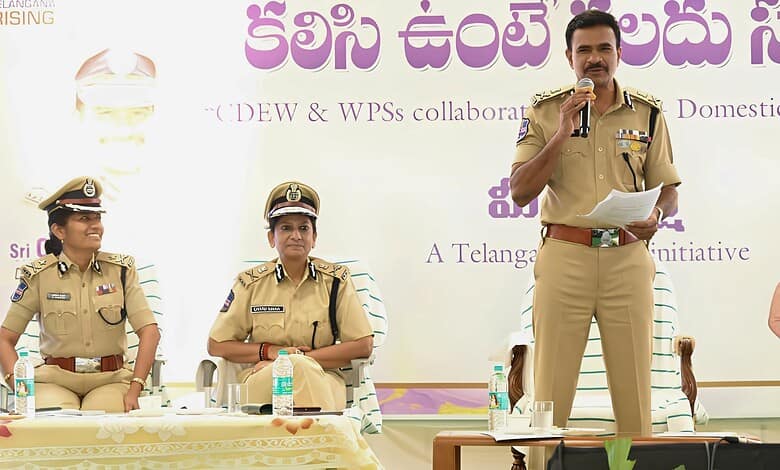 Police officers participating in a public event, with a male officer speaking into a microphone at a form.