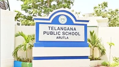 Telangana Public School Arutla signboard with greenery in the background.