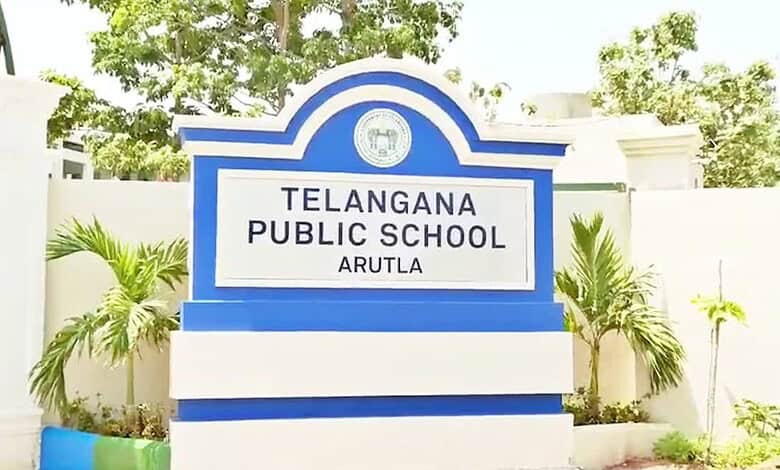 Telangana Public School Arutla signboard with greenery in the background.