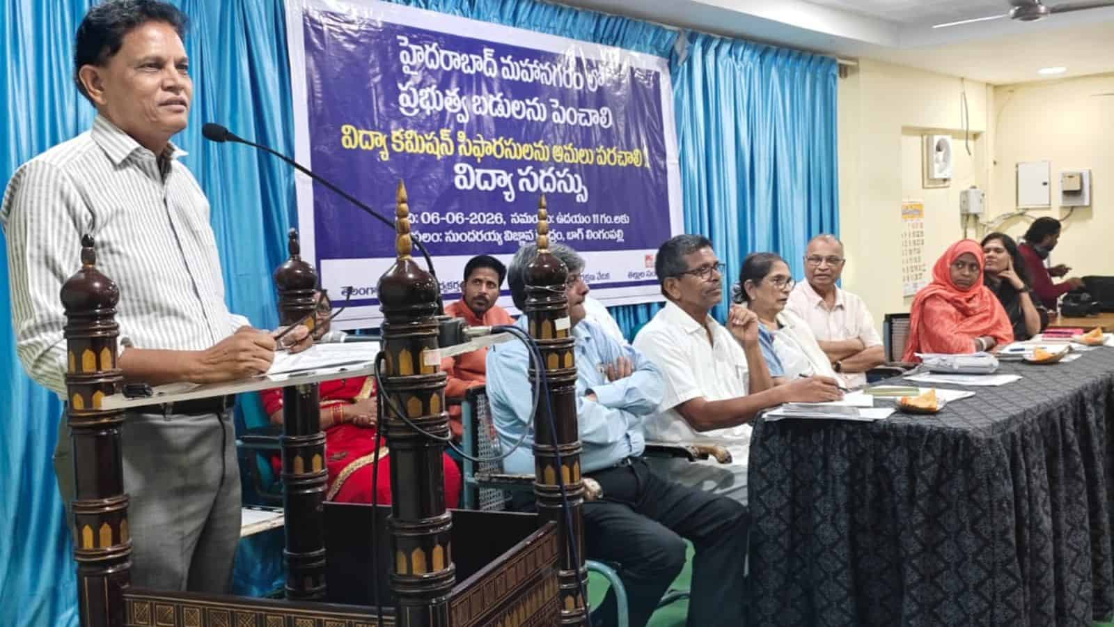 The image shows former Telangana Education Commission Chairman Akunuri Murali speaking at a meeting on public school education held at Sundaraiah Vignana Kendram on Saturday, June 6, 2026.