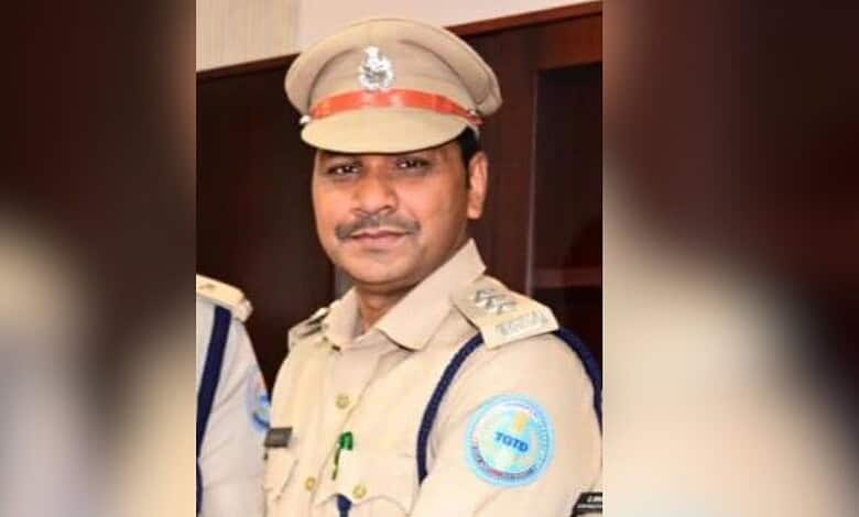 Bhupalpalli DTO in police uniform with badge and cap, smiling at camera.