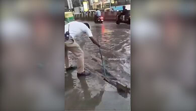 Video: Bengaluru traffic cops brave floodwaters to help public