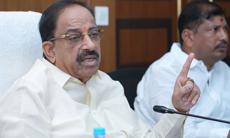 Tummala gesturing with his finger during a discussion at a formal meeting.