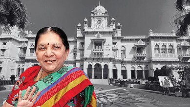 The Siasat Daily: Prominent Indian woman in traditional attire smiling in front of historic white palace.