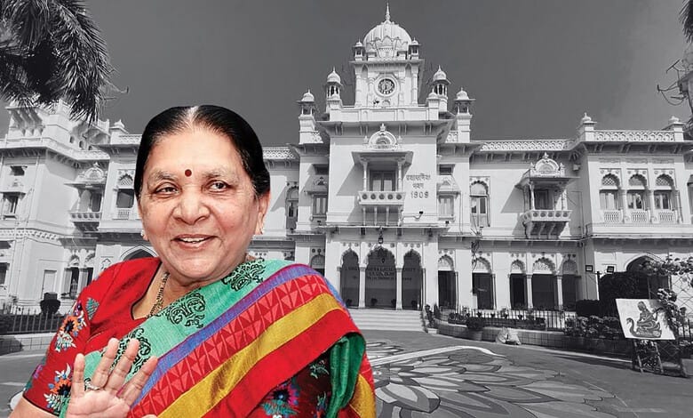 The Siasat Daily: Prominent Indian woman in traditional attire smiling in front of historic white palace.