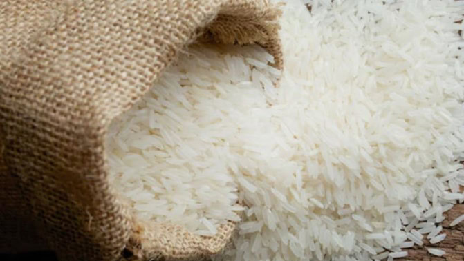 Rice grains spilling from a burlap sack, close-up shot.