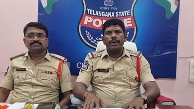 Police officers from Telangana State Police sitting at a press conference with a Telangana State Police b.