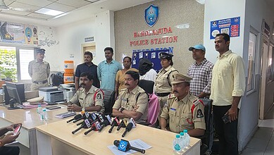 Police officers and civilians at Bagalkuda Police Station press conference in India.