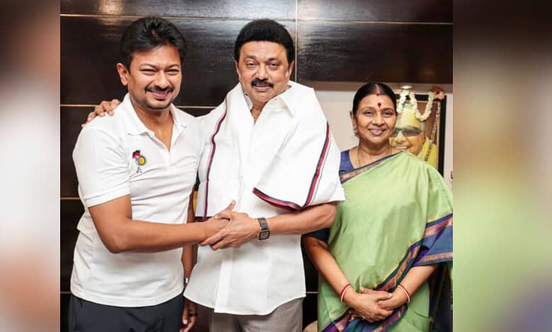 Celebration of a successful event with smiling individuals, including a man in white shirt and a woman in.
